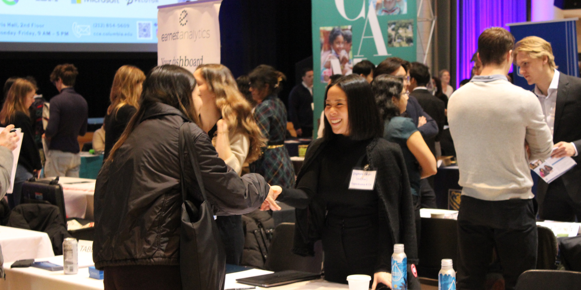 Recruiter greeting student at undergraduate career fair