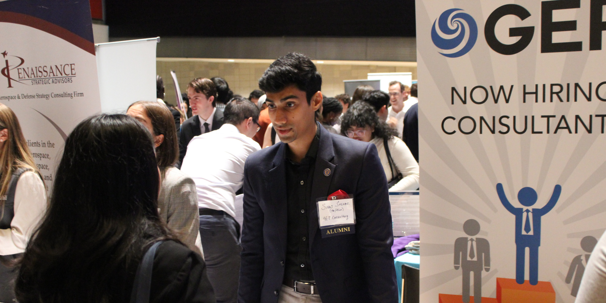 Recruiters speaking with students at a career fair.