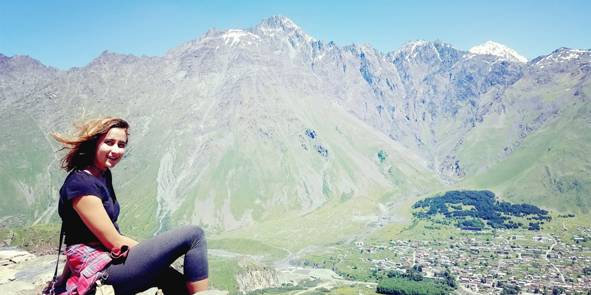 Student on the mountains looking at camera