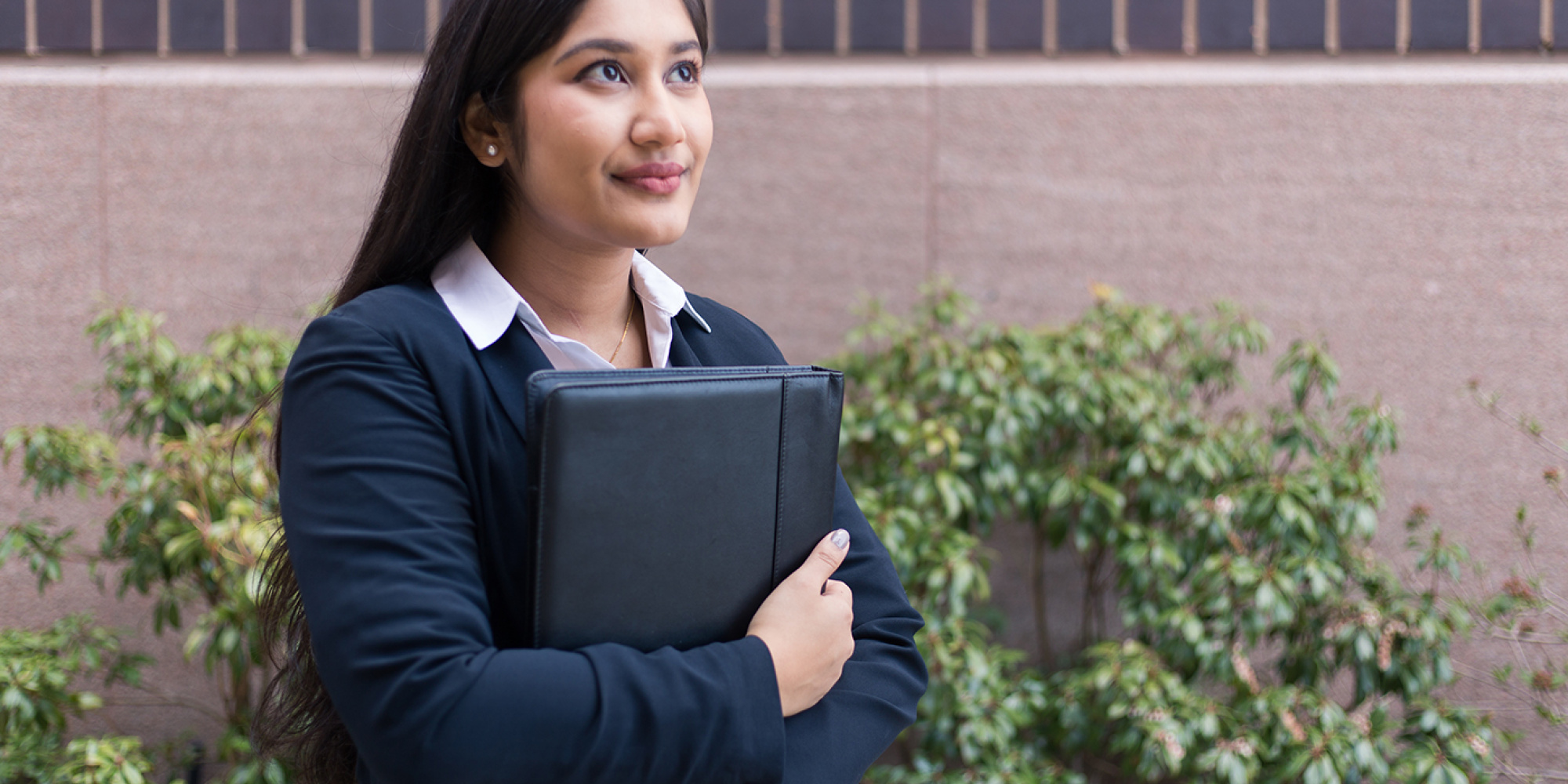 Student holding resume looking hopeful