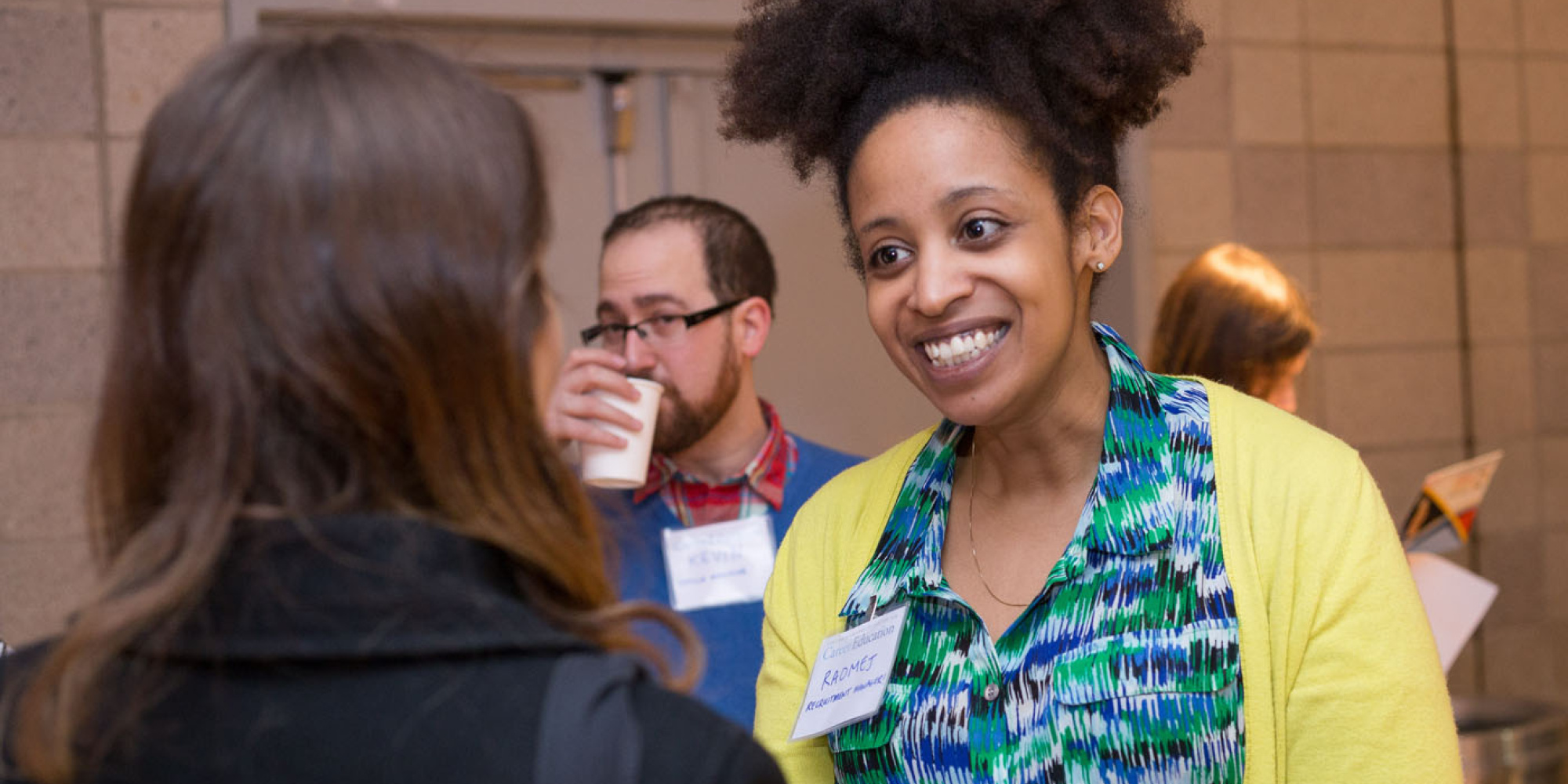 Employer smiling at student in conversation at career fair