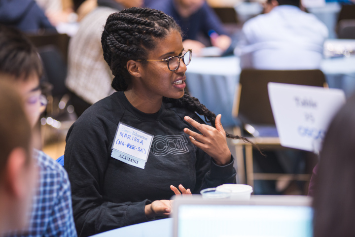 Alumni speaking with student at tech recruiting event