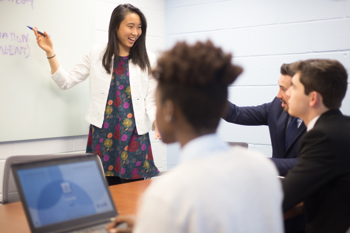 Student at whiteboard during meeting 