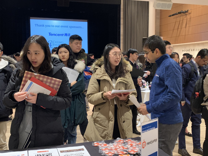 Employers from Next Jump speaking with students.