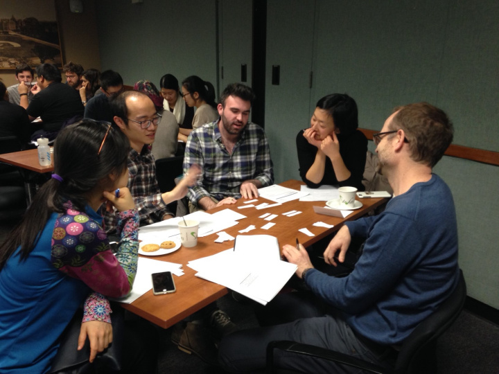 Students sitting around a table talking 