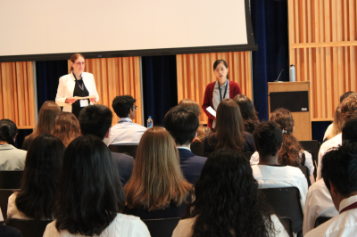 Two career counselors address a room full of students