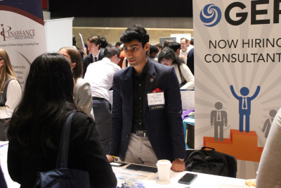 Recruiters speaking with students at a career fair.