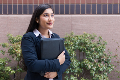 Student holding resume looking hopeful