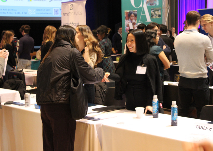 Recruiter greeting student at undergraduate career fair