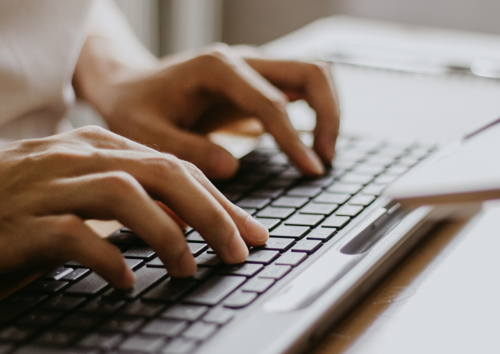 Hands typing on a keyboard