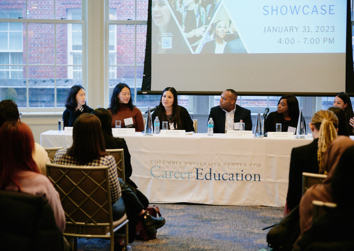 Five women and one man sit on a panel in front of a packed audience of students at the 2023 Diversity Recruiting Showcase on January 31, 2023