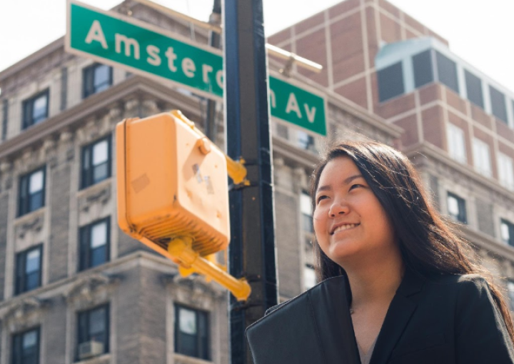 Student looking inspired at the intersection of 116th street and Amsterdam Ave.